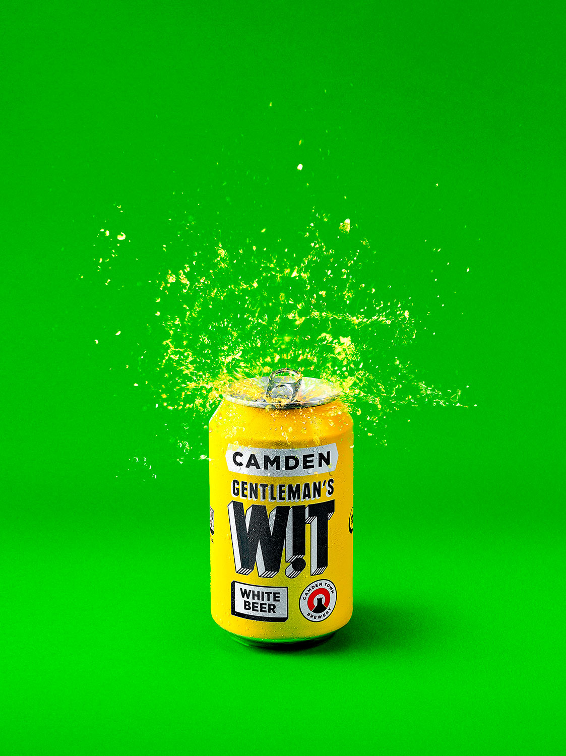 Camden Gentlemans Can with beer exploding and spraying out on a green background - London Food & Drinks Photographer