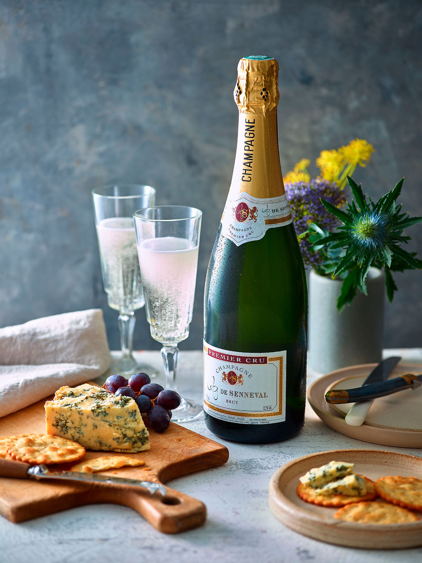 Champagne De Senneval Brut Bottle with two glasses and a cheese board  London Food & Drinks Photographer