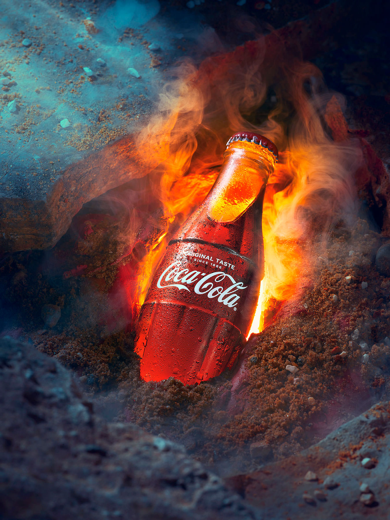 Coca Cola bottle being unearthed from a tomb with flames - London Food & Drinks Photographer