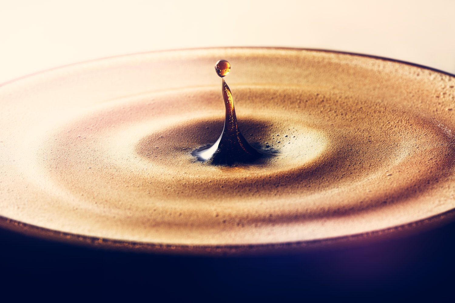 Expresso glass filled with fresh coffee with a drop falling and splashing into it creating ripples - London Food & Drinks Photographer