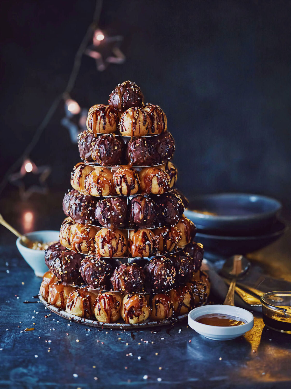 Croquembouche on blue background with bokeh fairylight background