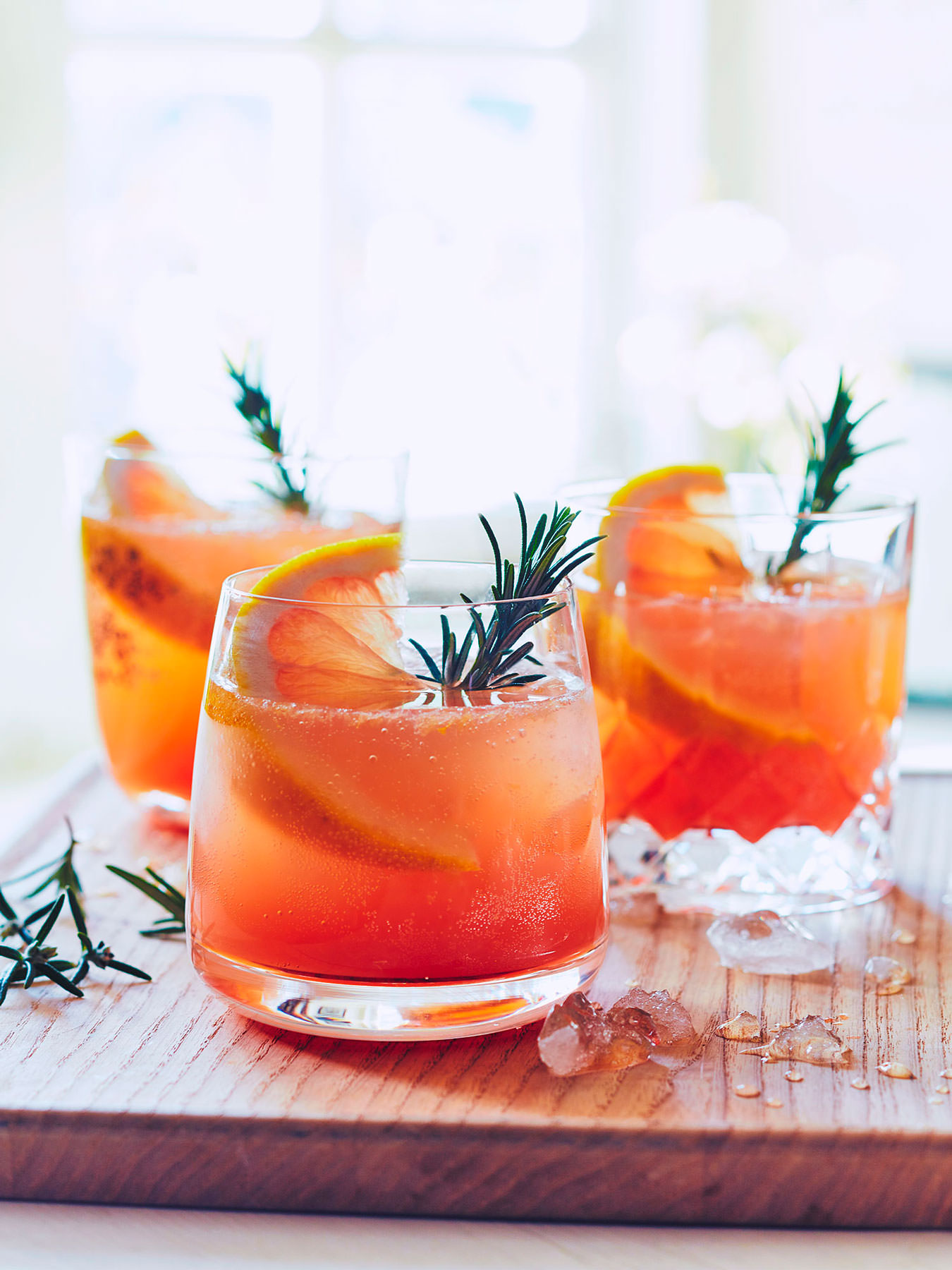 Grapefruit and Rosemary Cocktail on a table with spring sunlight coming through the window behind  - London Food & Drinks Photographer