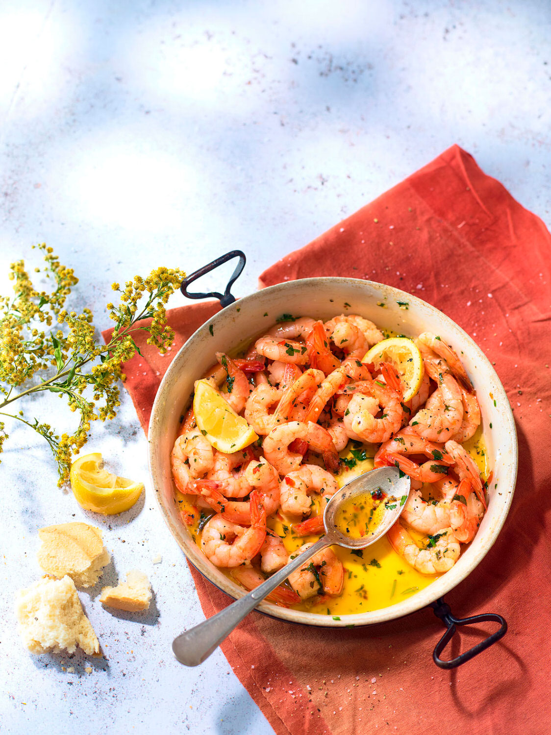 Garlic and Chilli Prawns served in a large skillet with crusty bread and lemon wedges. - London Food & Drinks Photographer