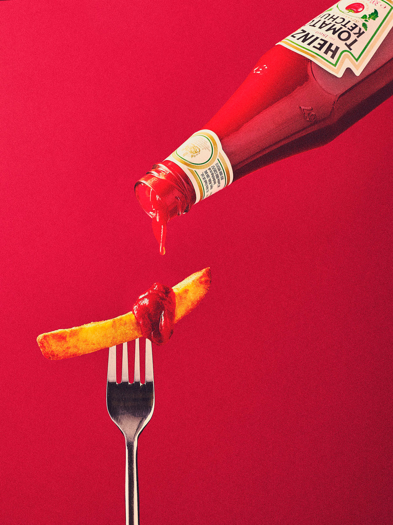 Heinz Ketchup dripping onto a chip help by a fork - London Food & Drinks Photographer
