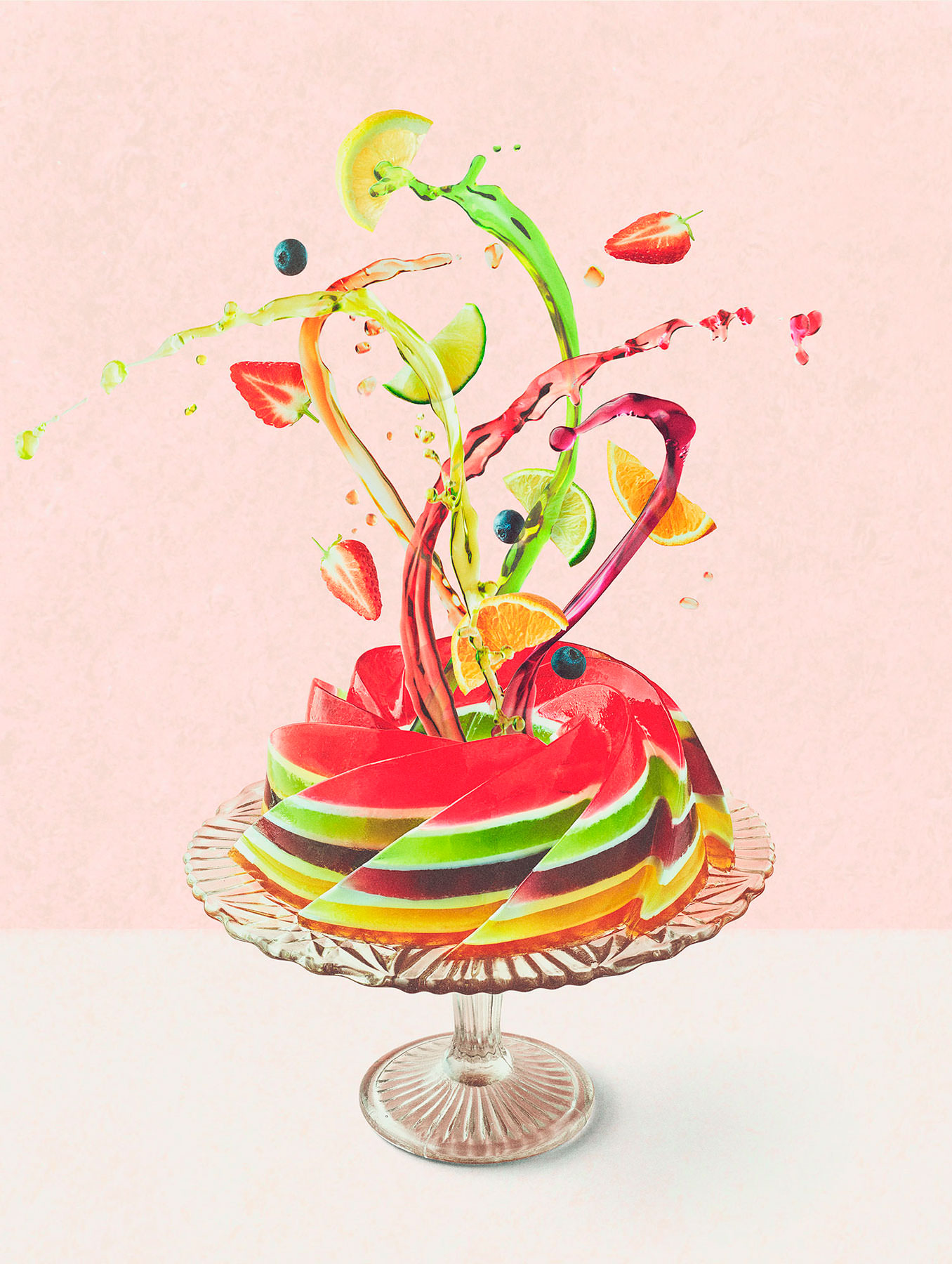 Layered Rainbow Jelly on a cake stand with liquid coloured jelly and fruit splashing out of the centre - London Food & Drinks Photographer