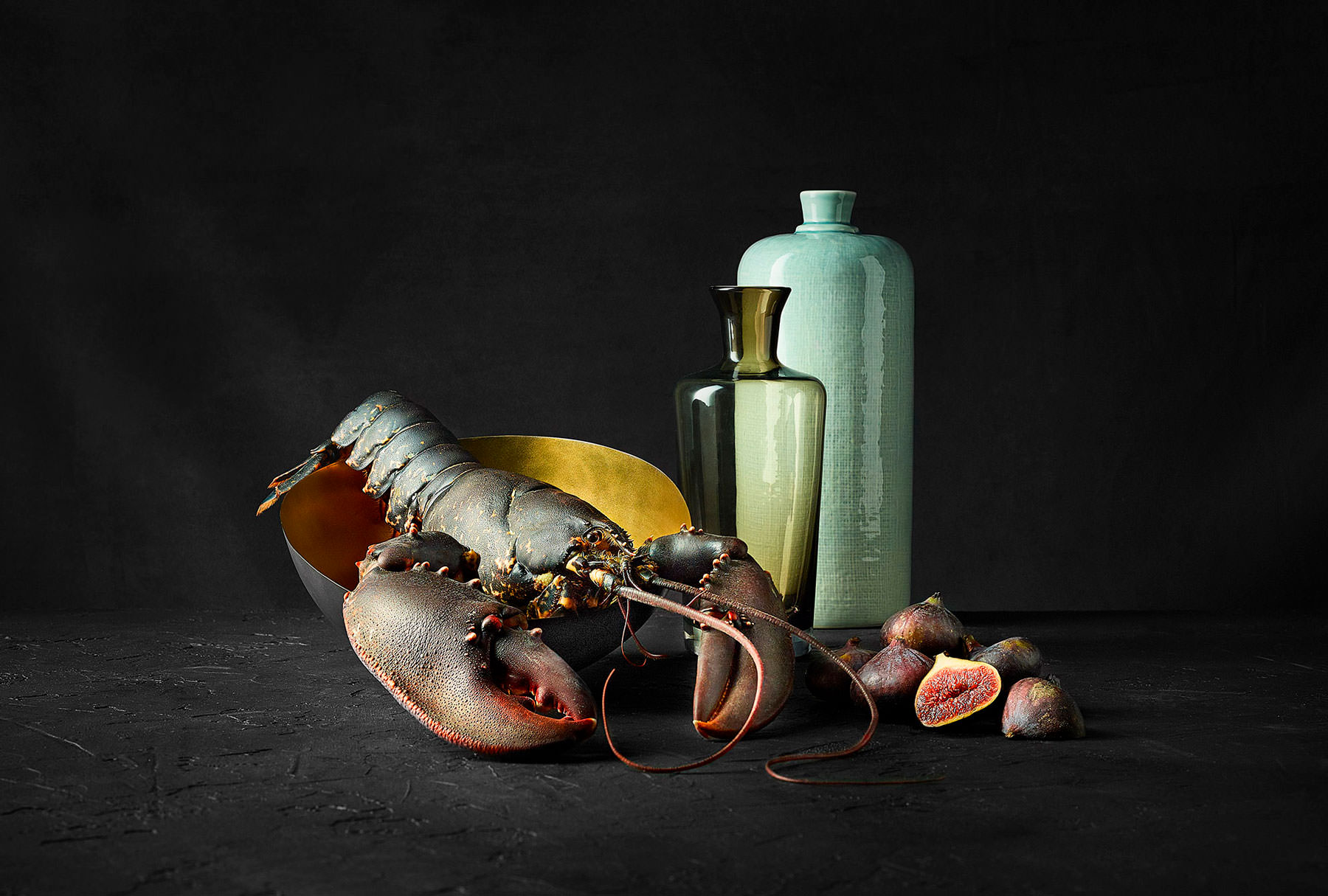 Still life photo showing Scottish Lobster and Figs set on a black backdrop - London Food & Drinks Photographer
