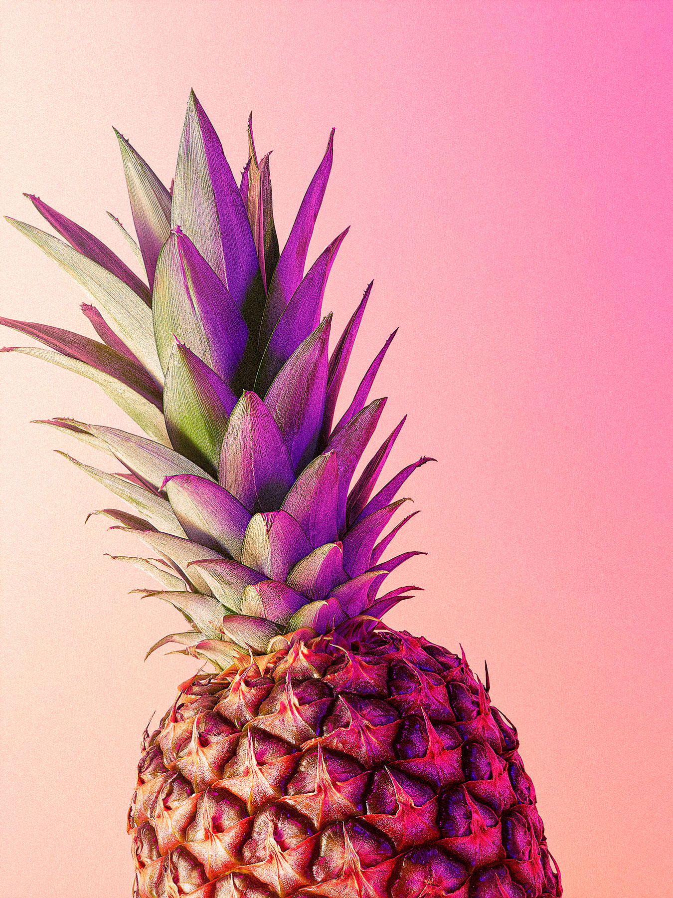 Whole pineapple on a orange and pink hued background - London Food & Drinks Photographer