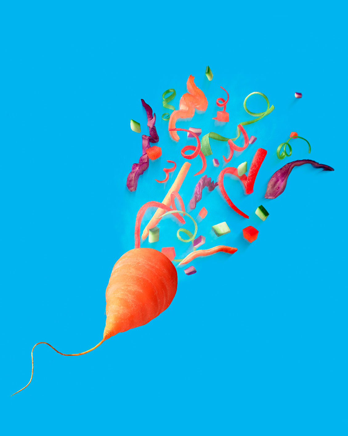 Chantenay Carrot made to look like a party popper with exploding vegetables flying out of it.  - London Food & Drinks Photographer