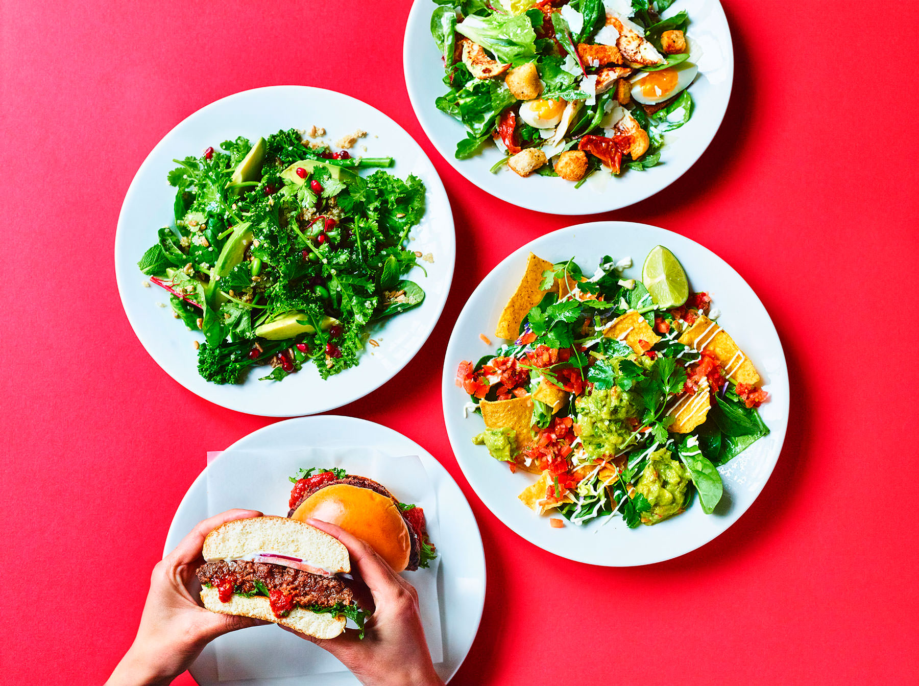 Biron burgers salads bowls on a red background - London Food & Drinks Photographer